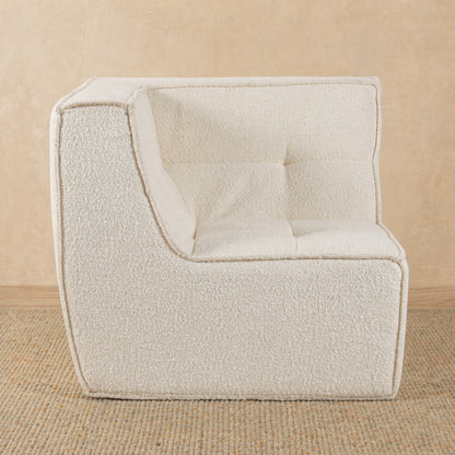Beige textured armchair on a beige background 