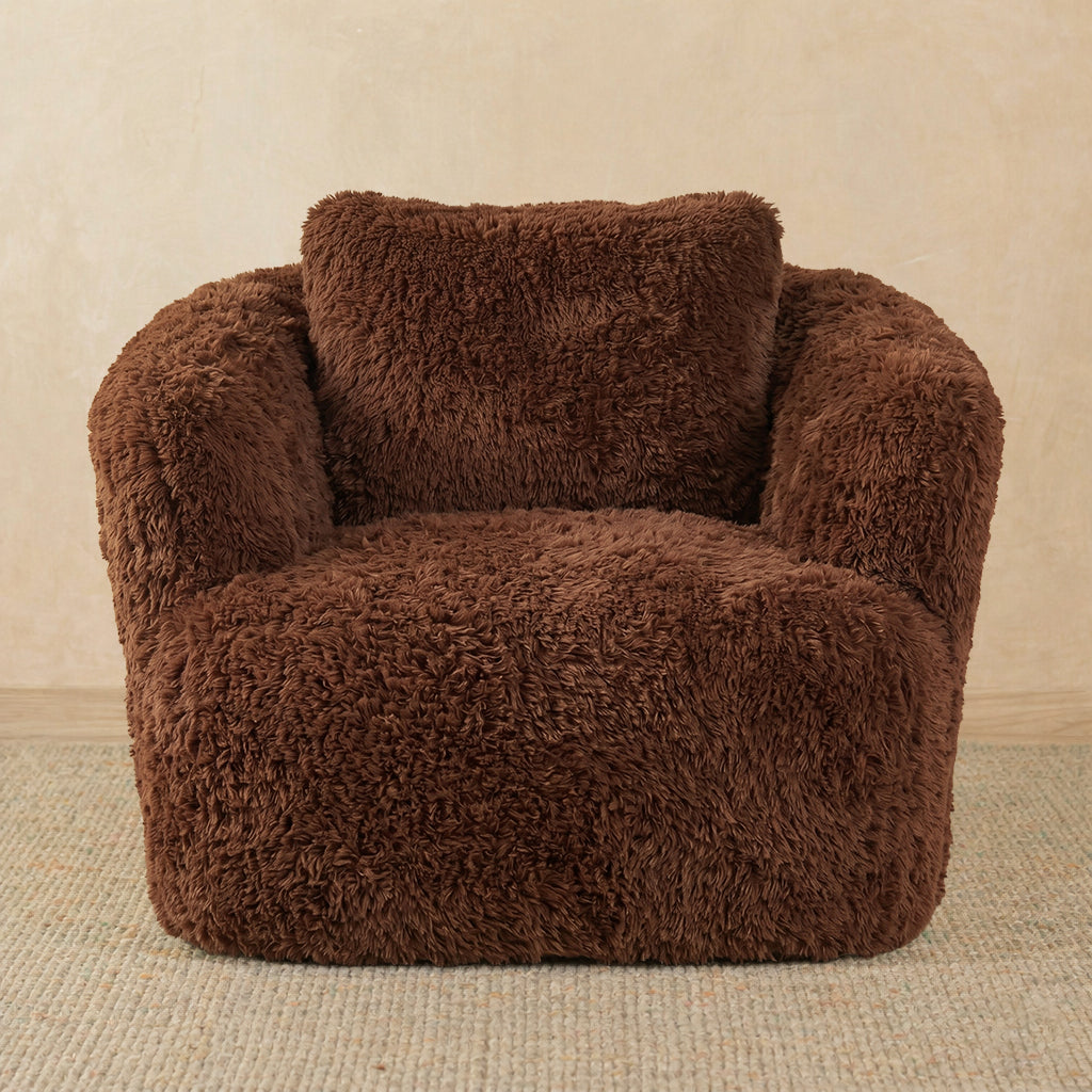 Brown fuzzy armchair on a beige background 