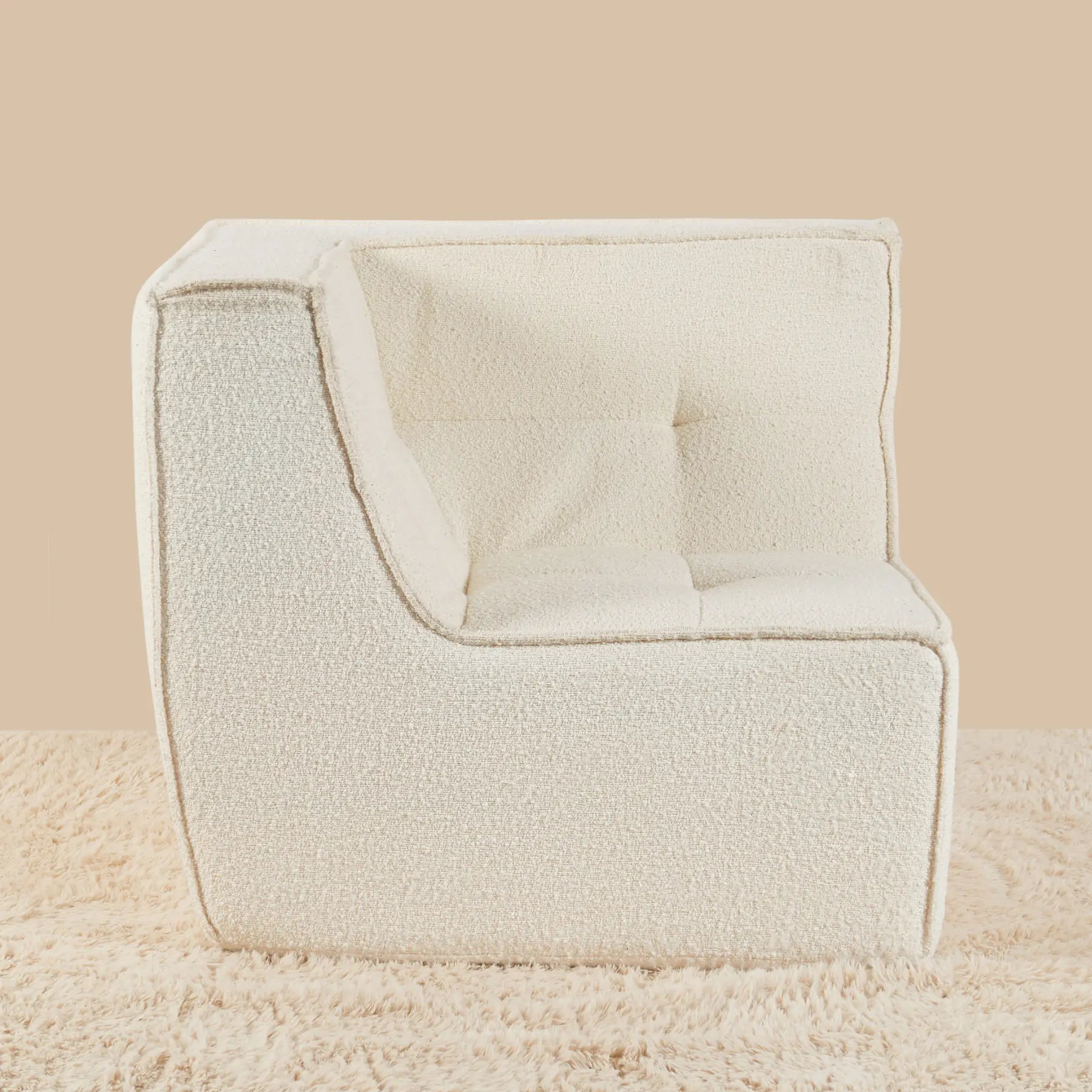Beige armchair on a beige background [color: ivory-boucle]