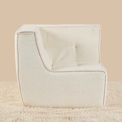 Beige armchair on a beige background [color: ivory-boucle]