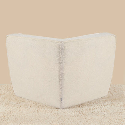 Beige wedge pillow on a beige background [color: ivory-boucle]