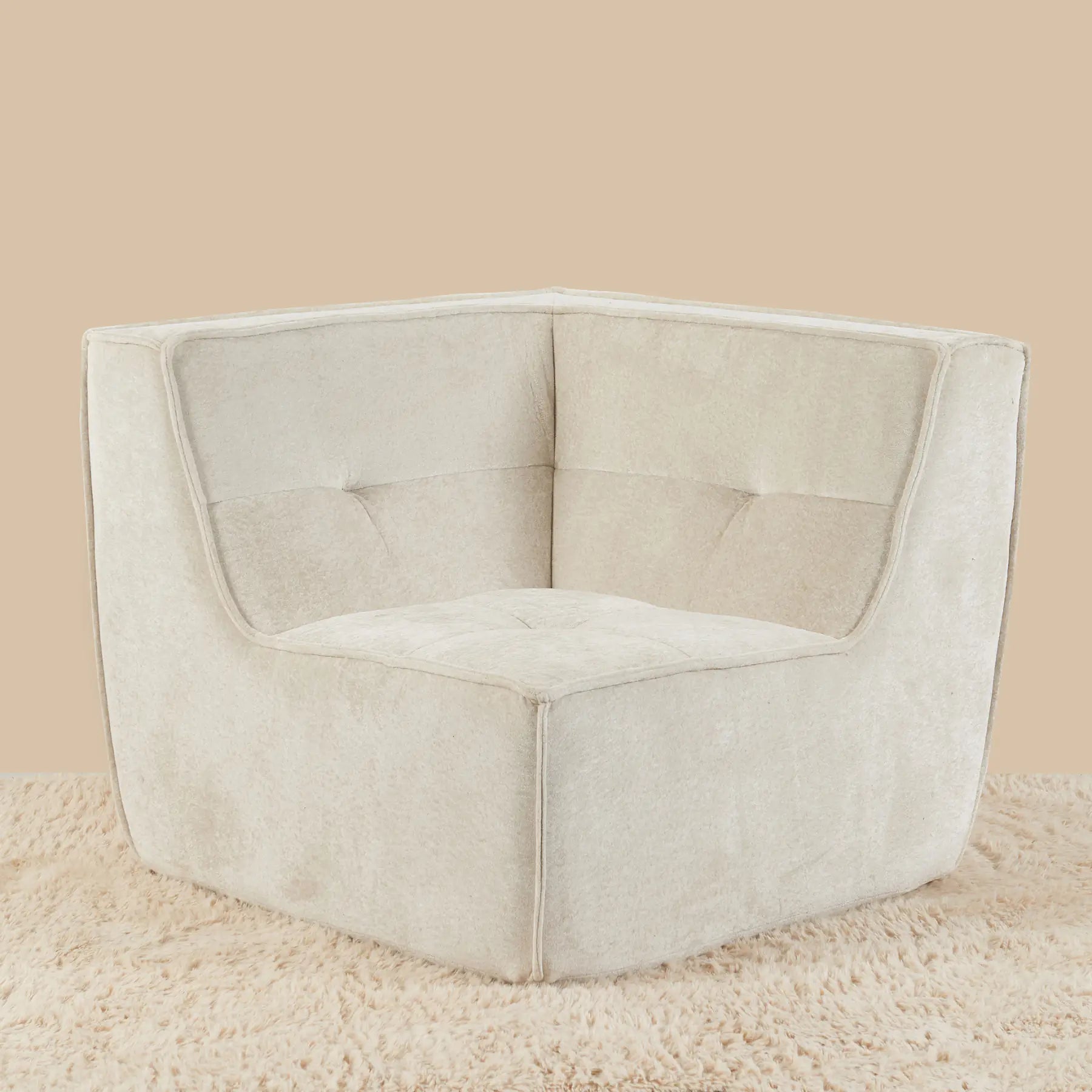 Beige corner chair on a beige carpet with a beige wall background [color: oat-snow-velvet]