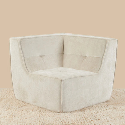 Beige corner chair on a beige carpet with a beige wall background [color: oat-snow-velvet]