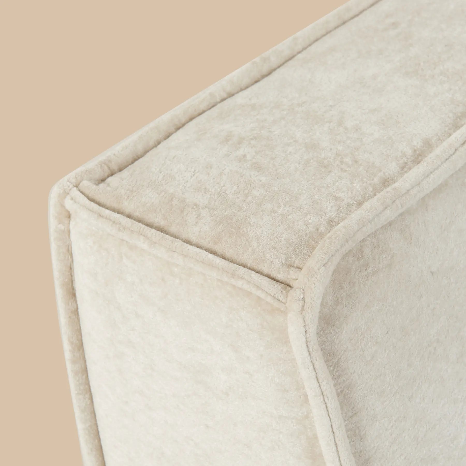 Close-up of a textured beige fabric with a subtle pattern on a beige background [color: oat-snow-velvet]