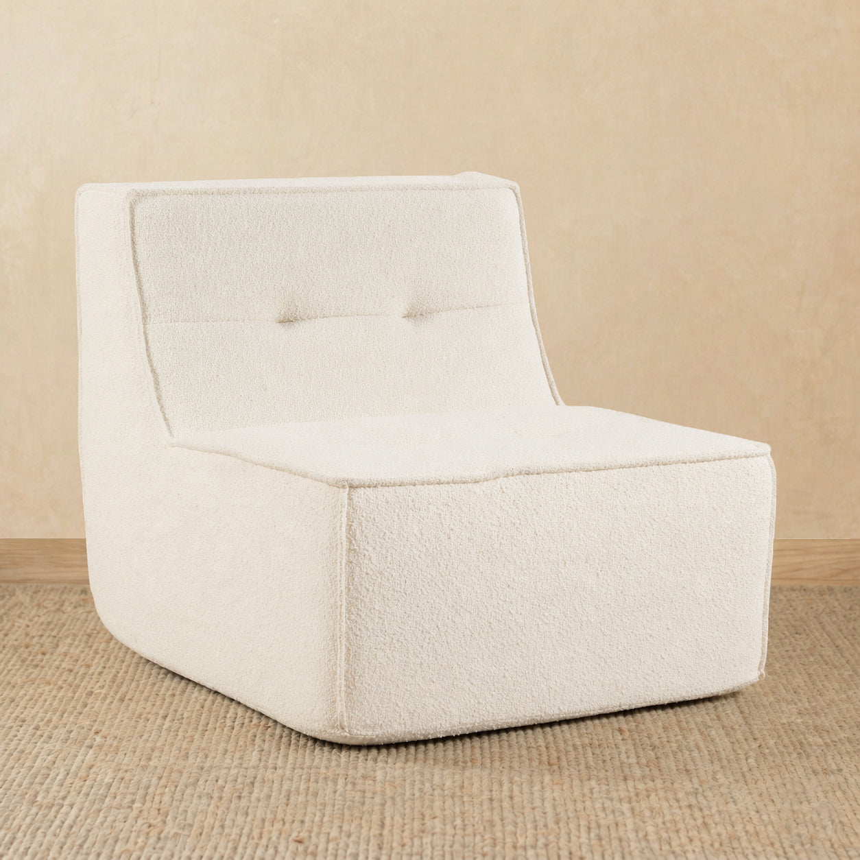 Beige armchair on a beige floor with a beige wall background 