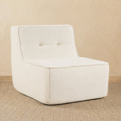 Beige armchair on a beige floor with a beige wall background 