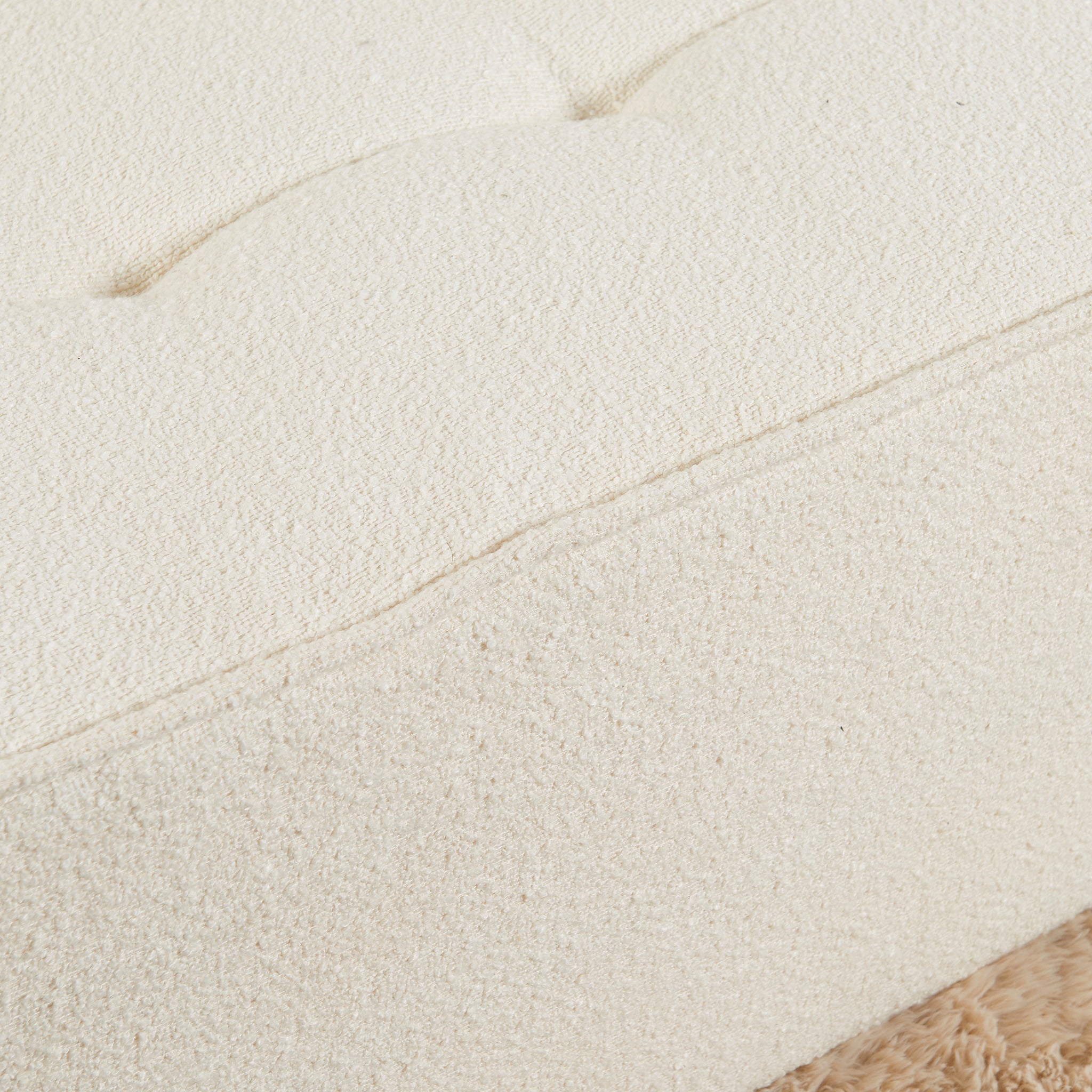 Close-up of a textured beige fabric surface 