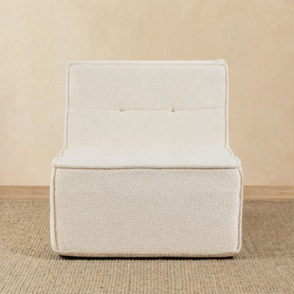 Beige armchair on a beige floor with a neutral wall background 