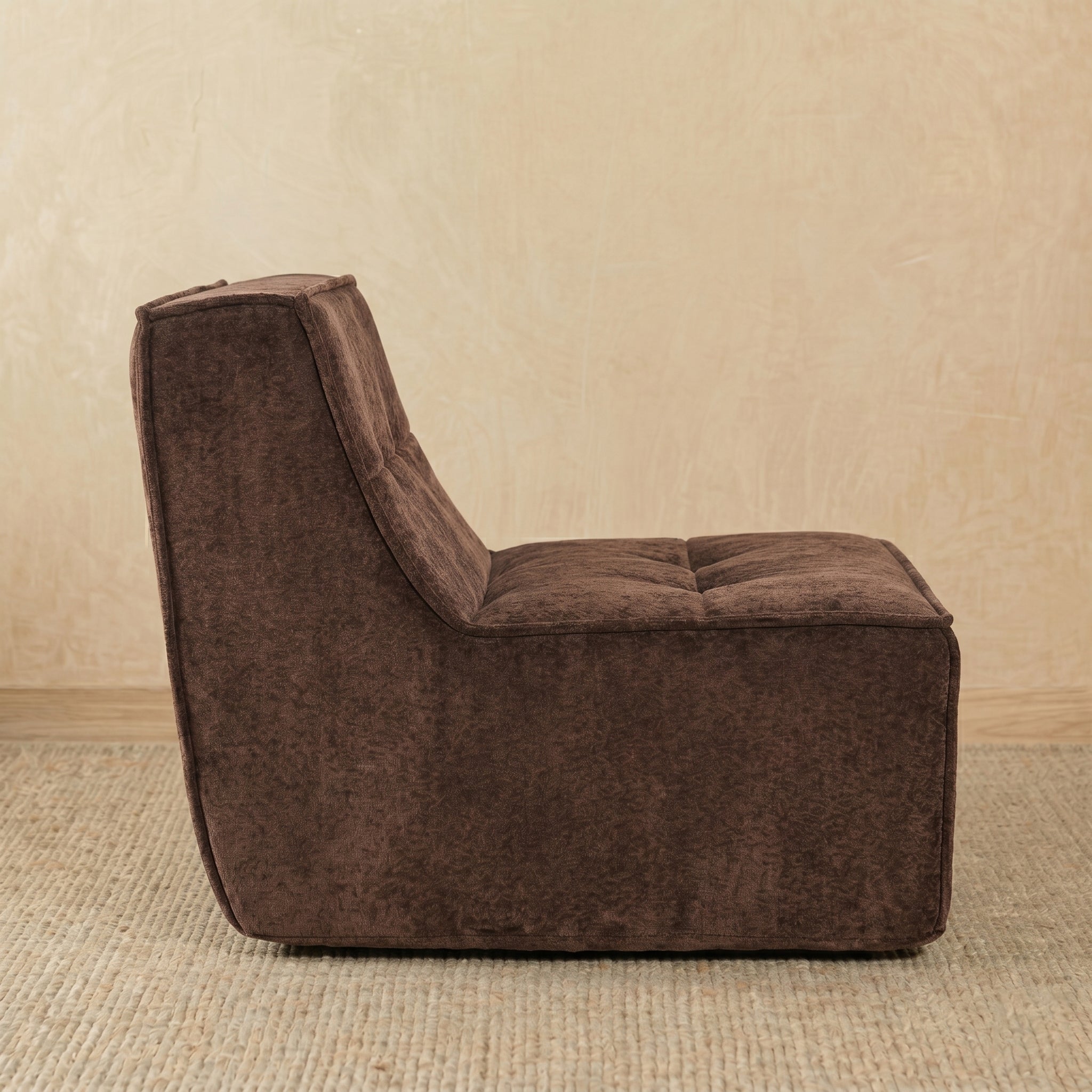 Brown textured armchair on a beige carpet with a beige wall background 