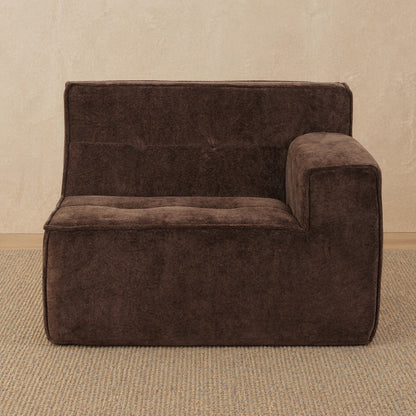 Brown sofa against a beige wall 