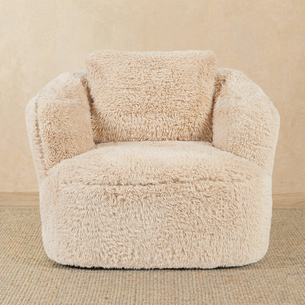 Beige fluffy armchair on a beige background 
