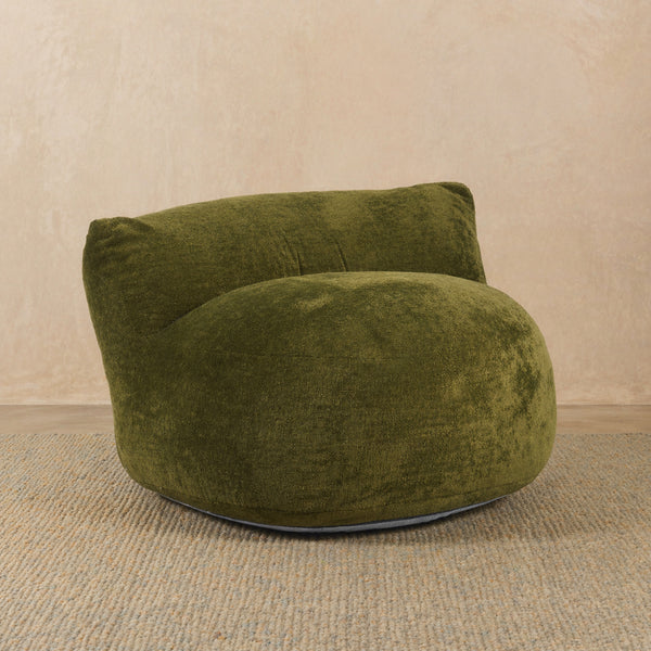 Green textured armchair on a beige carpet with a beige wall background #color_olive-fleece