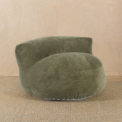 Green corduroy armchair on a beige background 