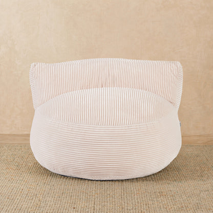 White corduroy ottoman on a beige background 