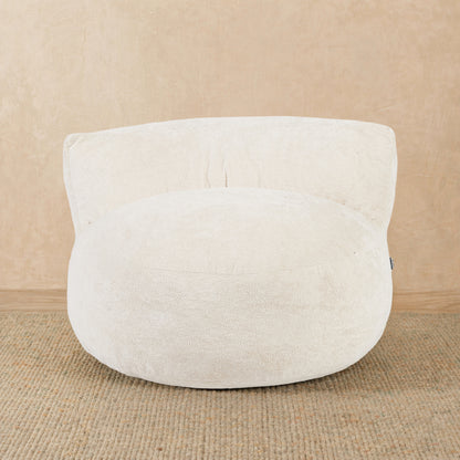 White textured pouf on a beige background 