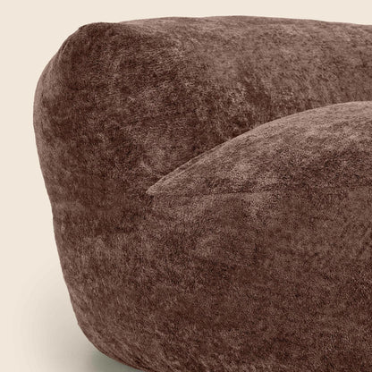 Close-up of a brown textured bean bag chair on a beige background
 