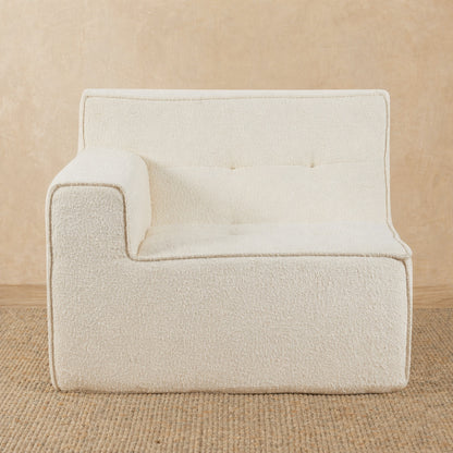 Beige armchair on a beige carpet with a neutral background 