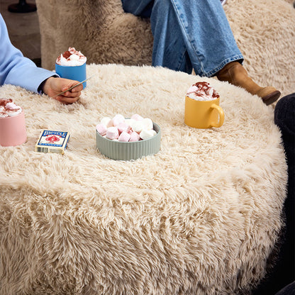 Round beige pouf on a winters day
