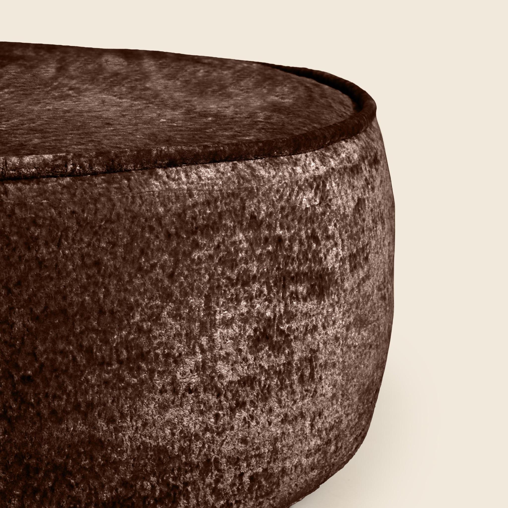 Close-up of a textured brown bowl on a beige background
