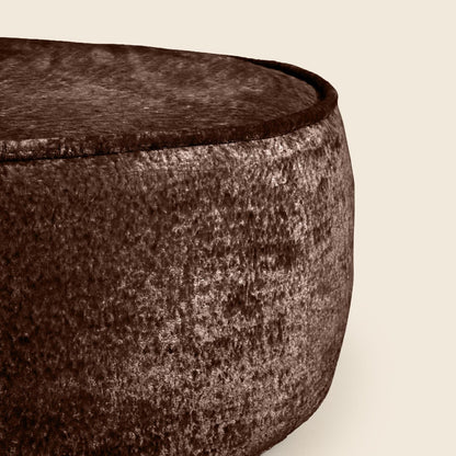 Close-up of a textured brown bowl on a beige background

