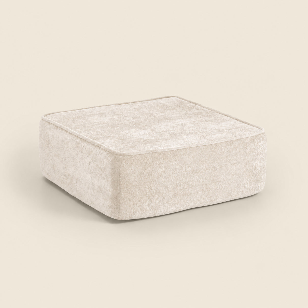 Cream textured square ottoman on a beige background. #color_oat-snow-velvet