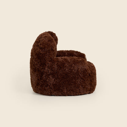Side view of the brown Beari Kids Armchair on a beige background 