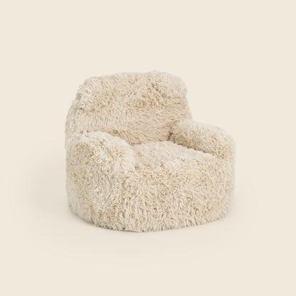 Cream Beari Kids Armchair, three-quarter front view on a beige background 