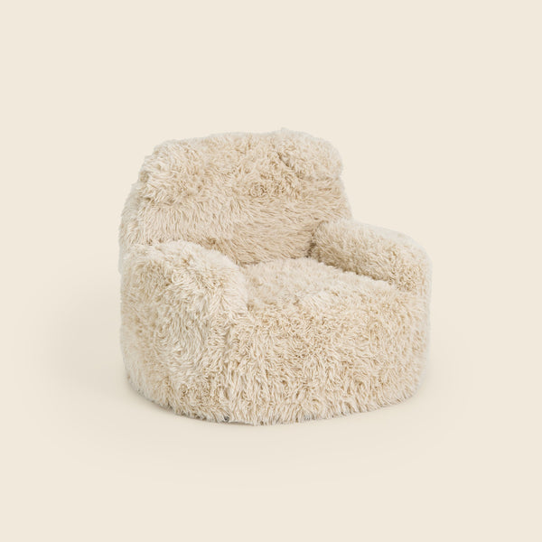 Cream Beari Kids Armchair, three-quarter front view on a beige background #color_cream-faux-fur