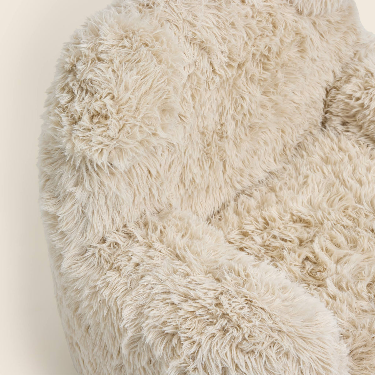 Close-up of the cream Beari Kids Armchair seat, arm and ears 