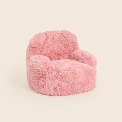 Pink Beari Kids Armchair, three-quarter front view on a beige background 