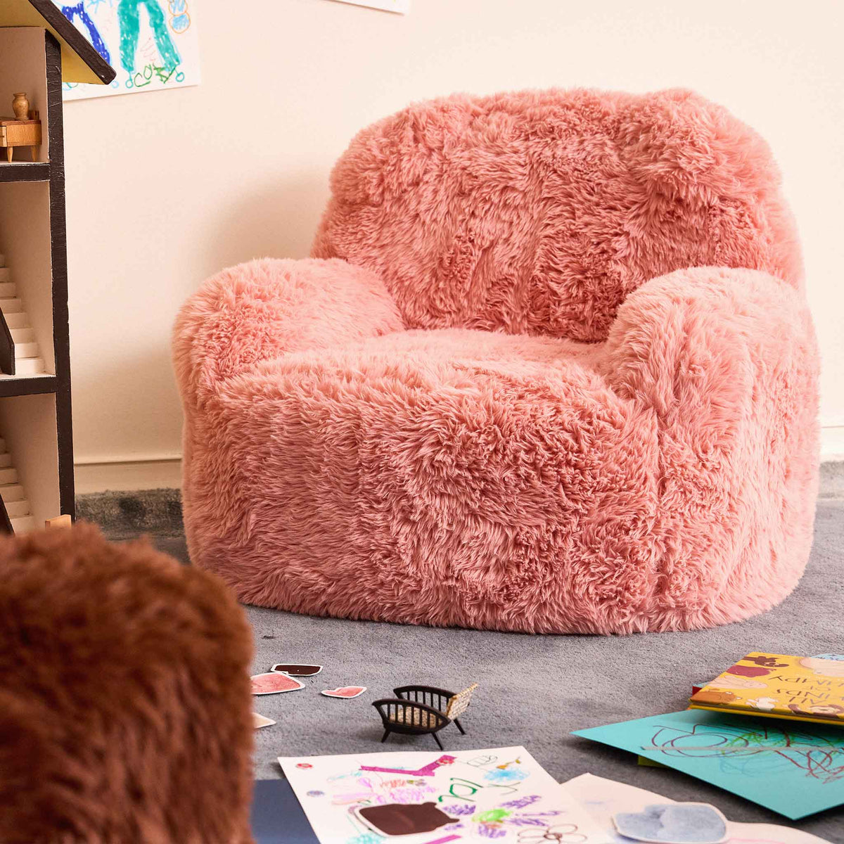 Pink Beari Kids Armchair in a playroom with drawings on the floor 