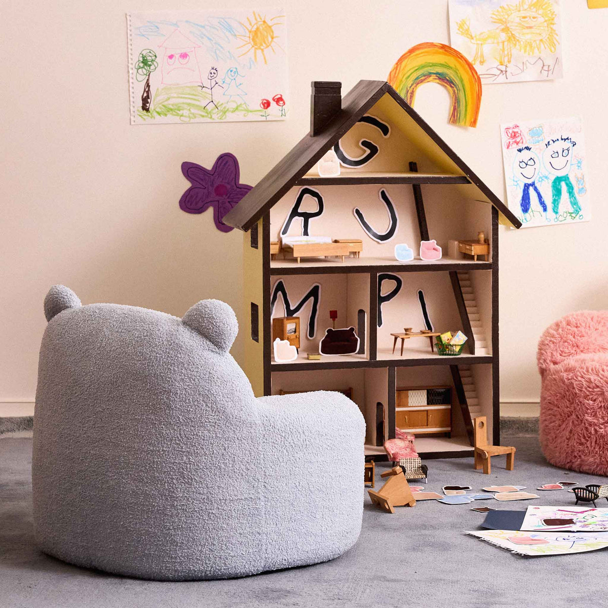 Blue Teddi Kids Armchair beside a wooden dollhouse in a playroom 