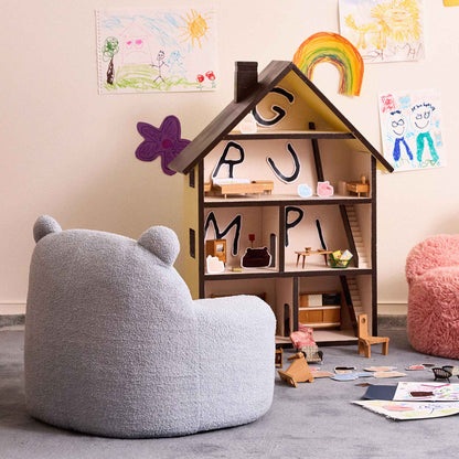 Blue Teddi Kids Armchair beside a wooden dollhouse in a playroom 
