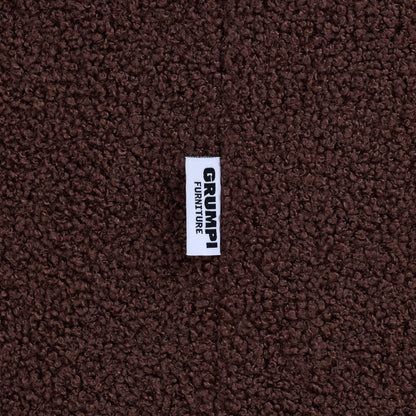 Close-up of the brown teddy fabric on the Teddi Kids Armchair, with the Grumpi Furniture label 