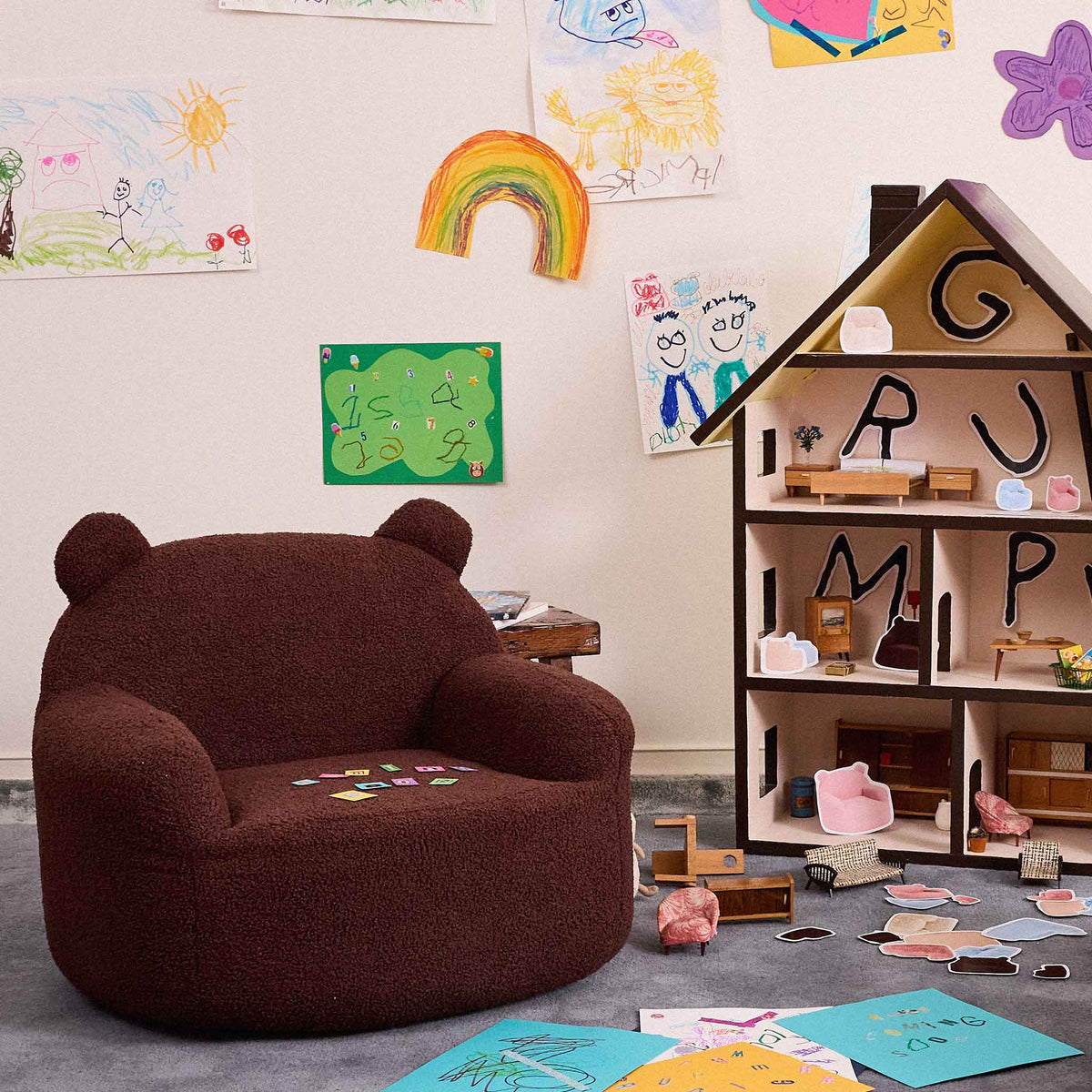Brown Teddi Kids Armchair with crayons on the seat in a playroom with a dollhouse 