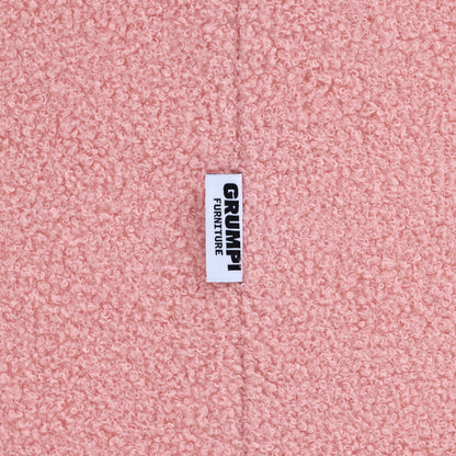 Close-up of the pink teddy fabric on the Teddi Kids Armchair, with the Grumpi Furniture label 