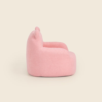 Side view of the pink Teddi Kids Armchair on a beige background 