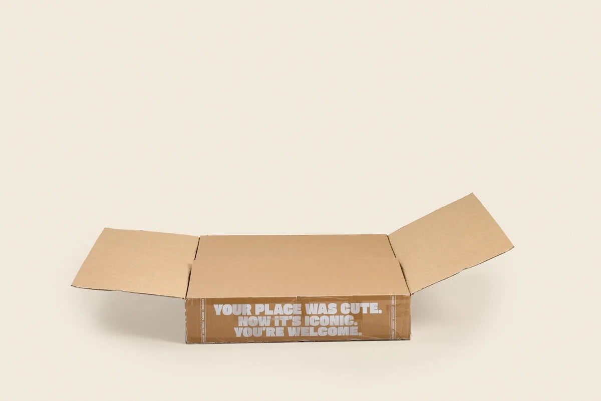 An open Grumpi box with the compressed chair inside